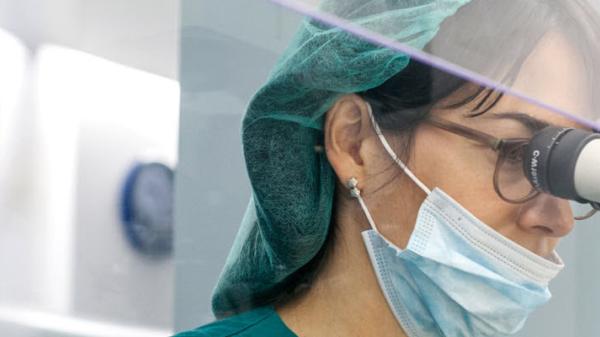 Image of female lab technician using microscope