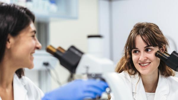 Baxter Employees smiling at each other in a lab